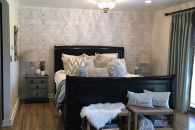 Example of a mid-sized country master medium tone wood floor and brown floor bedroom design in Denver with white walls