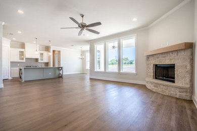 Cottage chic galley light wood floor open concept kitchen photo in Dallas with glass-front cabinets, granite countertops, gray backsplash, porcelain backsplash, stainless steel appliances, an island and multicolored countertops