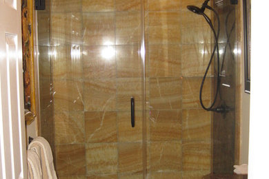 Example of a mid-sized transitional yellow tile and stone tile marble floor double shower design in Baltimore with an undermount sink, granite countertops, a one-piece toilet and beige walls