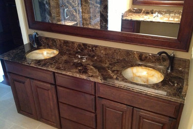 Elegant walk-in shower photo in Chicago with an undermount sink, raised-panel cabinets, dark wood cabinets and marble countertops
