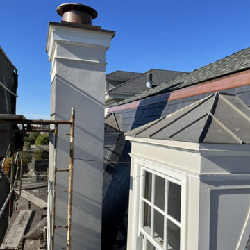 Slate Roof Replacement - New chimney cap, former roofs and panels