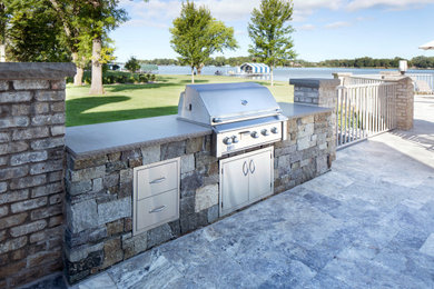 Hot tub - contemporary backyard stone and custom-shaped hot tub idea in Minneapolis