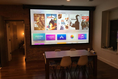 Example of a huge trendy enclosed dark wood floor home theater design in Boston with red walls and a projector screen