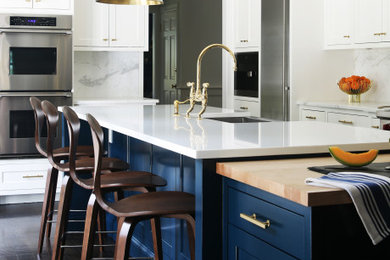 Kitchen - large transitional u-shaped brown floor kitchen idea in New York with an undermount sink, shaker cabinets, blue cabinets, gray backsplash, stainless steel appliances, an island and white countertops