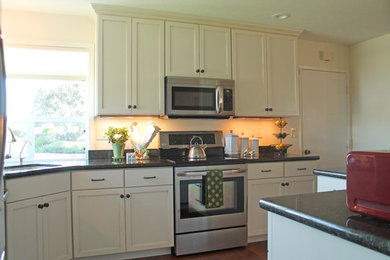 Inspiration for a small contemporary l-shaped medium tone wood floor eat-in kitchen remodel in San Francisco with an undermount sink, shaker cabinets, white cabinets, granite countertops, black backsplash, stone slab backsplash, stainless steel appliances and an island