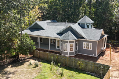 Large elegant gray one-story concrete fiberboard and clapboard house exterior photo in Charlotte with a shingle roof and a gray roof
