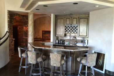 Example of a mid-sized transitional l-shaped gray floor wet bar design in Denver with an undermount sink, granite countertops, shaker cabinets, black cabinets, gray backsplash and gray countertops