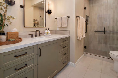 Design ideas for a medium sized modern shower room bathroom in Orange County with shaker cabinets, brown cabinets, an alcove shower, beige tiles, porcelain tiles, beige walls, porcelain flooring, a submerged sink, engineered stone worktops, beige floors, a hinged door, white worktops, a single sink and a built in vanity unit.