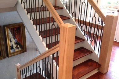 Example of a mid-century modern staircase design in Charlotte