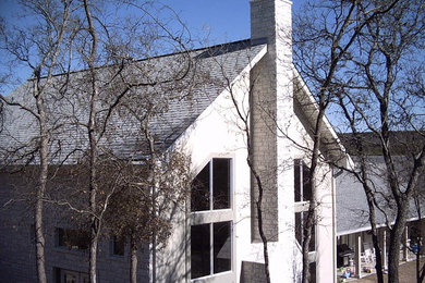 Large elegant white two-story mixed siding gable roof photo in Austin