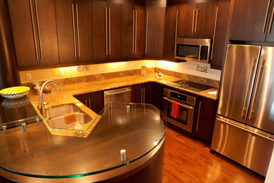 Small trendy u-shaped open concept kitchen photo in Orlando with an undermount sink, flat-panel cabinets, dark wood cabinets, granite countertops, stainless steel appliances and a peninsula