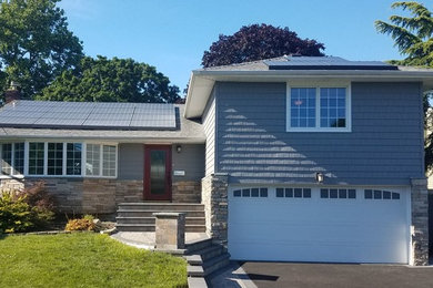 Inspiration for a small gray two-story vinyl house exterior remodel in New York with a shingle roof