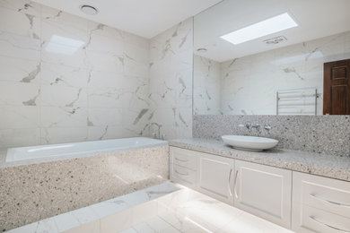 This is an example of a mid-sized contemporary master bathroom in Melbourne with shaker cabinets, white cabinets, a drop-in tub, multi-coloured tile, ceramic tile, ceramic floors, a single vanity and a freestanding vanity.