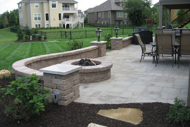 Inspiration for a backyard stone patio remodel in Kansas City with no cover
