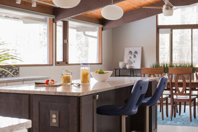 Inspiration for a large modern l-shaped porcelain tile eat-in kitchen remodel in Boston with an undermount sink, shaker cabinets, white cabinets, granite countertops, blue backsplash, mosaic tile backsplash, stainless steel appliances and an island