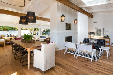 Mid-sized beach style medium tone wood floor great room photo in Los Angeles with white walls