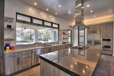Large contemporary l-shaped eat-in kitchen in San Francisco with an undermount sink, flat-panel cabinets, distressed cabinets, quartz benchtops, stainless steel appliances, porcelain floors and with island.