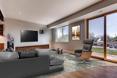 Huge urban formal and open concept dark wood floor living room photo in Denver with gray walls and a wall-mounted tv
