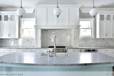 Large trendy l-shaped dark wood floor eat-in kitchen photo in Chicago with a farmhouse sink, white cabinets, granite countertops, white backsplash, stainless steel appliances, an island, shaker cabinets and porcelain backsplash