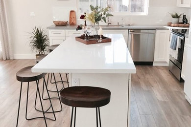Mid-sized mid-century modern galley eat-in kitchen photo in San Francisco with shaker cabinets, quartzite countertops, subway tile backsplash and an island