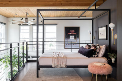 This is an example of a contemporary loft-style bedroom in Seattle with black walls, concrete floors and grey floor.