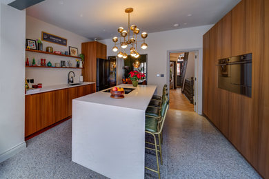 Design ideas for a contemporary grey and brown open plan kitchen in London with a submerged sink, flat-panel cabinets, brown cabinets, engineered stone countertops, integrated appliances, ceramic flooring, an island, grey floors, white worktops and feature lighting.