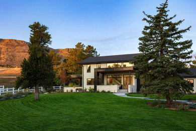 Inspiration for a contemporary two-story stucco house exterior remodel in Denver with a shingle roof and a black roof