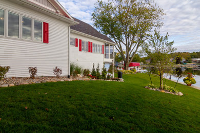 Inspiration for a large coastal white one-story vinyl and clapboard exterior home remodel in Other with a shingle roof