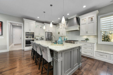 Inspiration for a transitional kitchen remodel with recessed-panel cabinets, white cabinets, granite countertops and an island