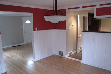 Example of a transitional light wood floor enclosed dining room design in Philadelphia with red walls