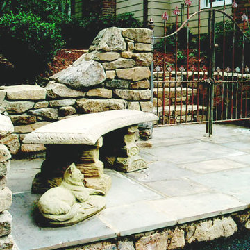 Wrought Iron Gate with Stacked Stone Wall