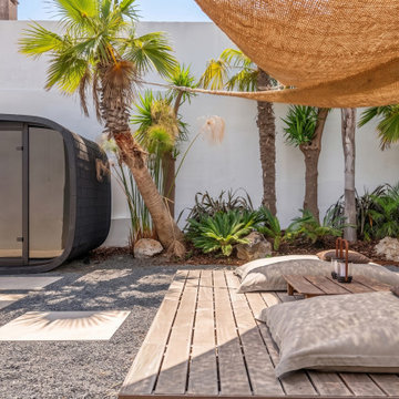 Patio lounge with black seating module and palms, Alfragide