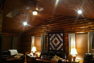 Inspiration for a mid-sized rustic medium tone wood floor living room remodel in New York with a wood stove and a stone fireplace