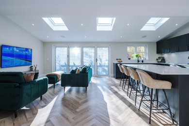 Inspiration for a large modern kitchen in Manchester with a submerged sink, shaker cabinets, grey cabinets, quartz worktops, white splashback, granite splashback, stainless steel appliances, an island and white worktops.