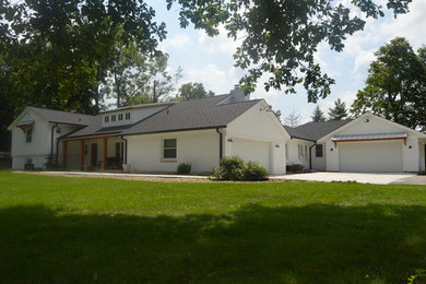 Large country white two-story brick house exterior idea in Indianapolis with a shingle roof