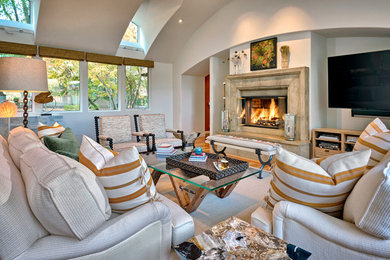Living room - large mediterranean open concept medium tone wood floor and brown floor living room idea in Austin with white walls, a standard fireplace, a wall-mounted tv and a stone fireplace