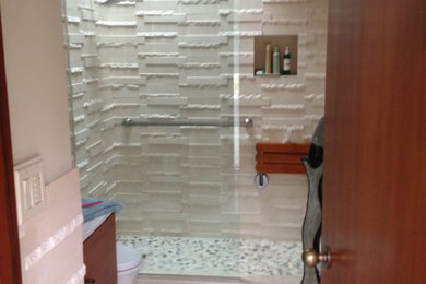 Elegant stone tile bathroom photo in San Francisco with light wood cabinets