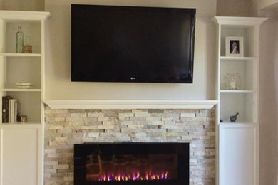 Inspiration for a mid-sized transitional living room remodel in Other with beige walls, a ribbon fireplace, a stone fireplace and a wall-mounted tv