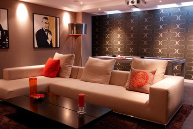 Mid-sized contemporary enclosed home theatre in London with brown walls, dark hardwood floors and a projector screen.