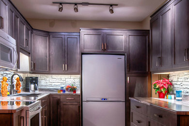 Example of a small minimalist u-shaped eat-in kitchen design in Vancouver with a double-bowl sink, dark wood cabinets, stone tile backsplash and white appliances