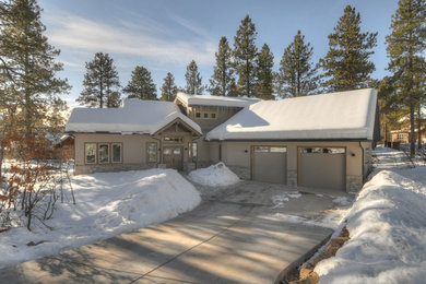Mid-sized arts and crafts gray two-story stucco exterior home photo in Albuquerque with a shingle roof