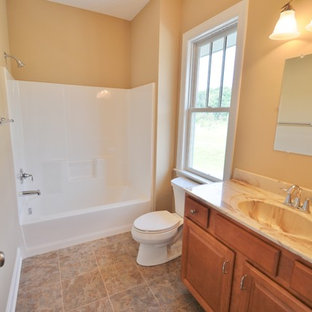 Bathroom - craftsman ceramic tile ceramic floor bathroom idea in Other with raised-panel cabinets and medium tone wood cabinets