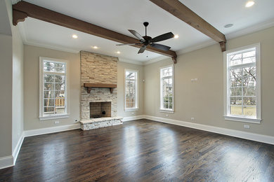 Large arts and crafts open concept dark wood floor and brown floor family room photo in Houston with gray walls, a standard fireplace and a stone fireplace