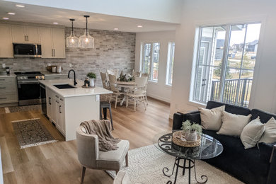 Living room - contemporary vinyl floor, beige floor and brick wall living room idea in Other