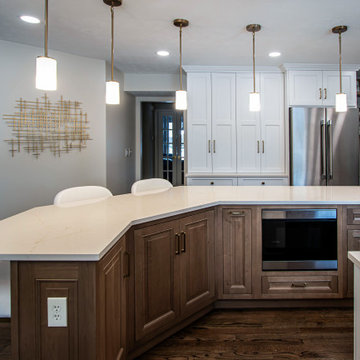 Two Tone Kitchen with Floating Shelves and Island Seating and Updated Fireplace