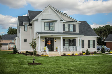 Large transitional beige two-story mixed siding exterior home photo in Other with a shingle roof