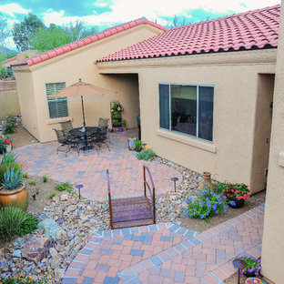 This is an example of a large side yard partial sun xeriscape in Phoenix with a garden path and brick pavers.