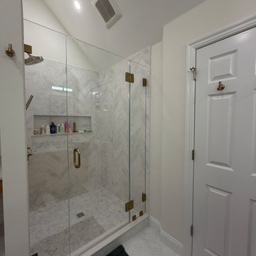 Custom Bathroom Renovation with Marble Herringbone Shower and Glass Enclosure