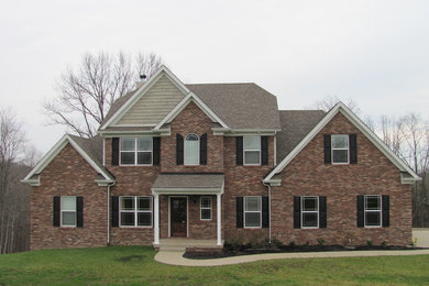 Example of a classic brick exterior home design in Other