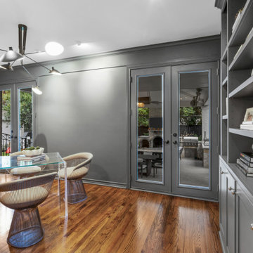 Contemporary Study Room with Industrial Brick Accent Wall and Modern Lighting